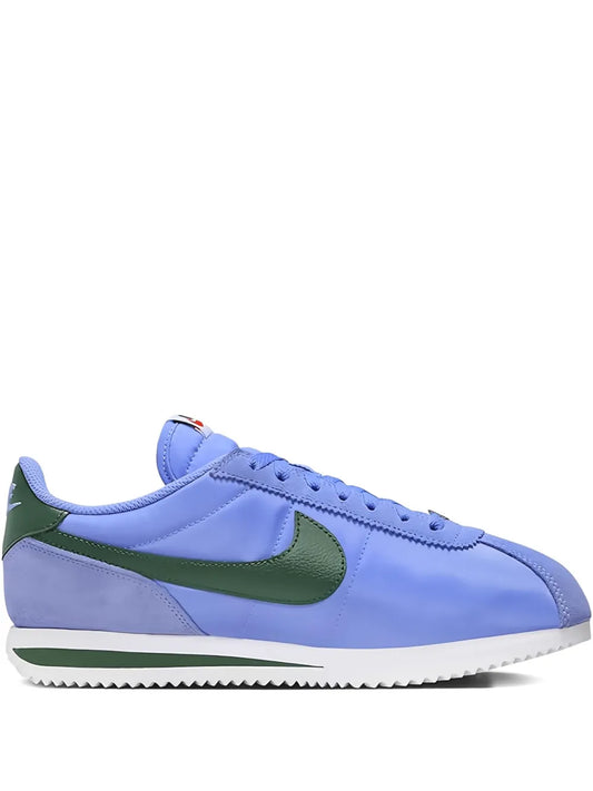 Nike Cortez blue low-top lace-up sneakers with green swoosh and white sole