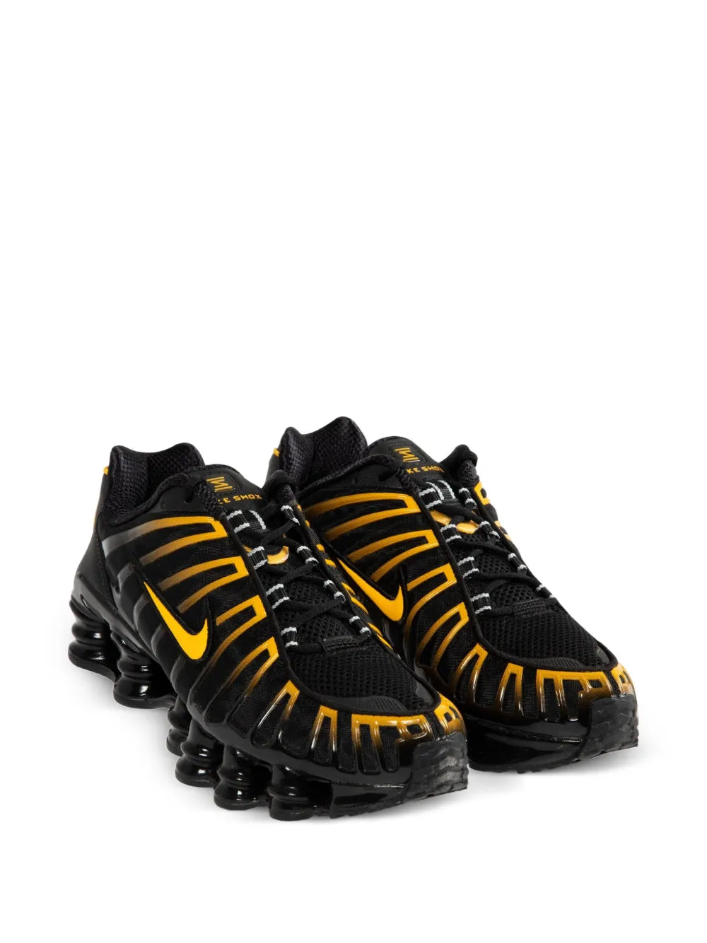 Black running shoes with yellow swoosh, lace-up mesh upper, and chunky air sole