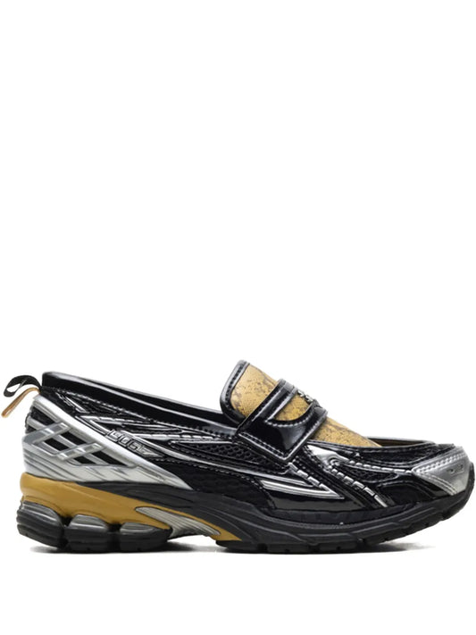 Black-and-silver sneaker with gold snake-print strap and chunky athletic sole
