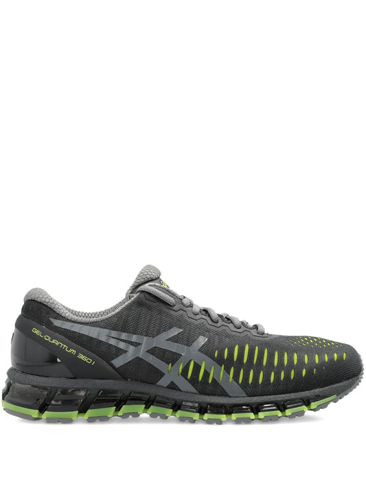 Grey ASICS running shoe with neon green details and cushioned tread sole