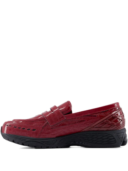 Red slip-on sneakers with black outsole and textured side panels