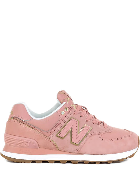 Pink lace-up women's New Balance 574 sneakers with green N logo and gum outsole