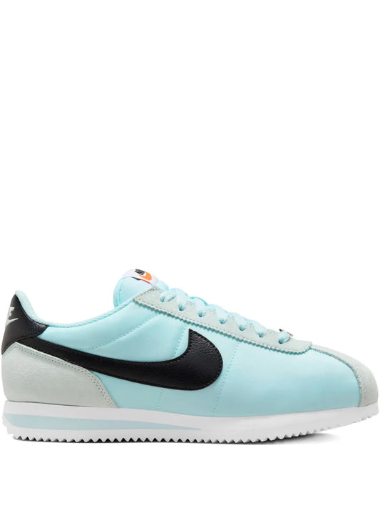 Nike Cortez low-top sneakers, light blue with black Swoosh and white sole