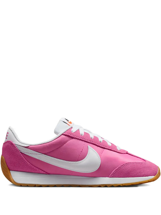 Nike lace-up sneaker in pink with white swoosh and gum rubber sole