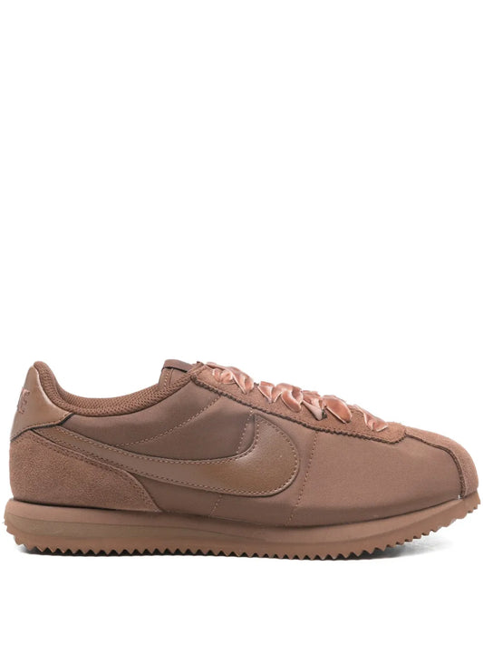 Brown Nike Cortez suede sneakers with lace-up closure and side swoosh detail