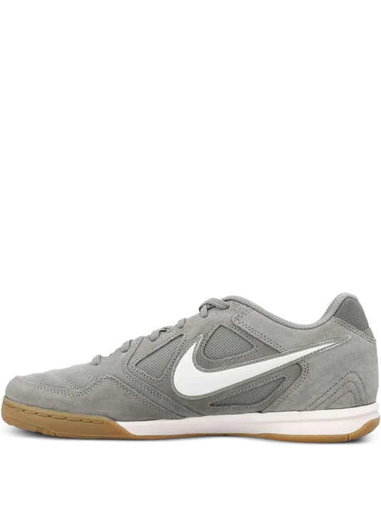 Gray Nike mesh panelled trainers with lace-up front, swoosh logo, gum sole.