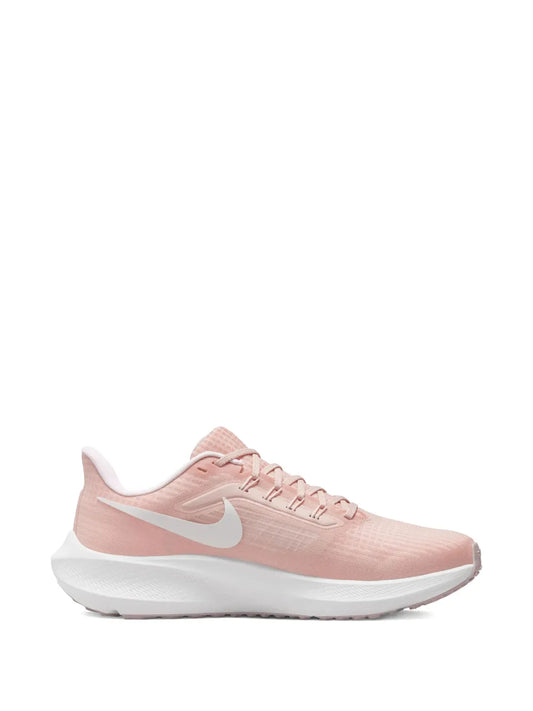 Nike pink running shoe with lace-up mesh upper and white sole