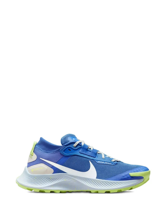 Blue Nike Gore-Tex trail running shoes with neon green accents and white swoosh
