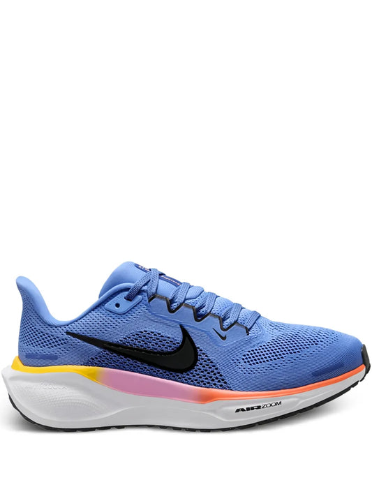 Blue Nike road running shoe with black swoosh, white midsole, orange heel accent