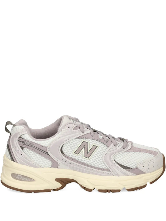 New Balance 530 sneaker in white and light gray with N logo patch and tan outsole