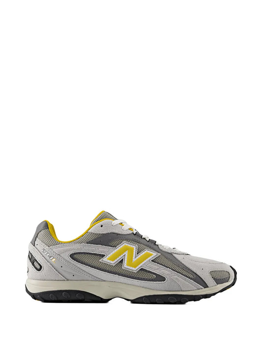 Grey New Balance 204L low-top sneakers, white laces, yellow accents