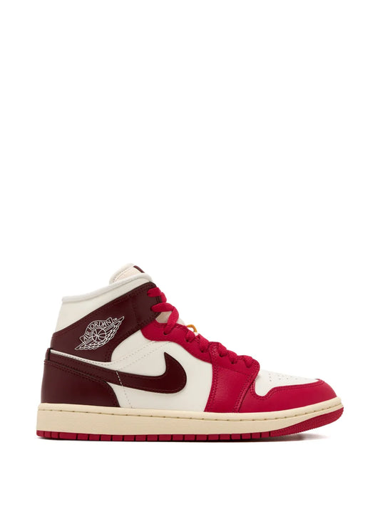 Mid-top sneaker with red and white panels, dark red overlays, lace-up.