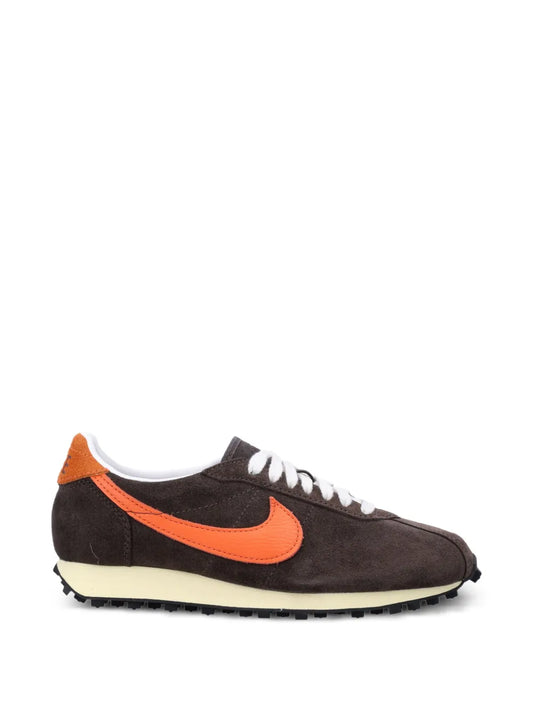 Suede low-top sneaker in dark brown with orange swoosh and white laces