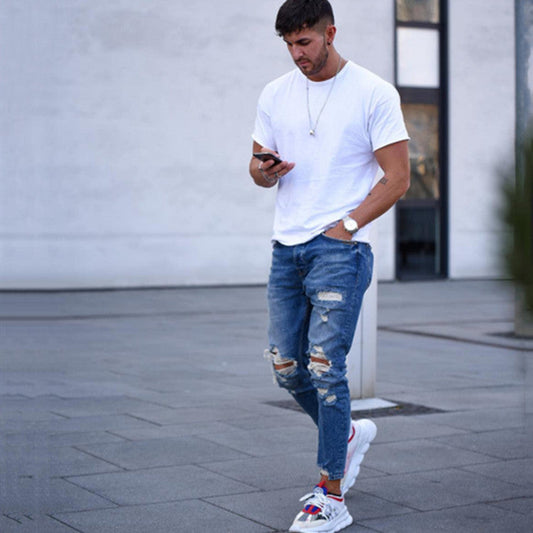 Men's deep blue distressed jeans with ripped knees and faded patchwork