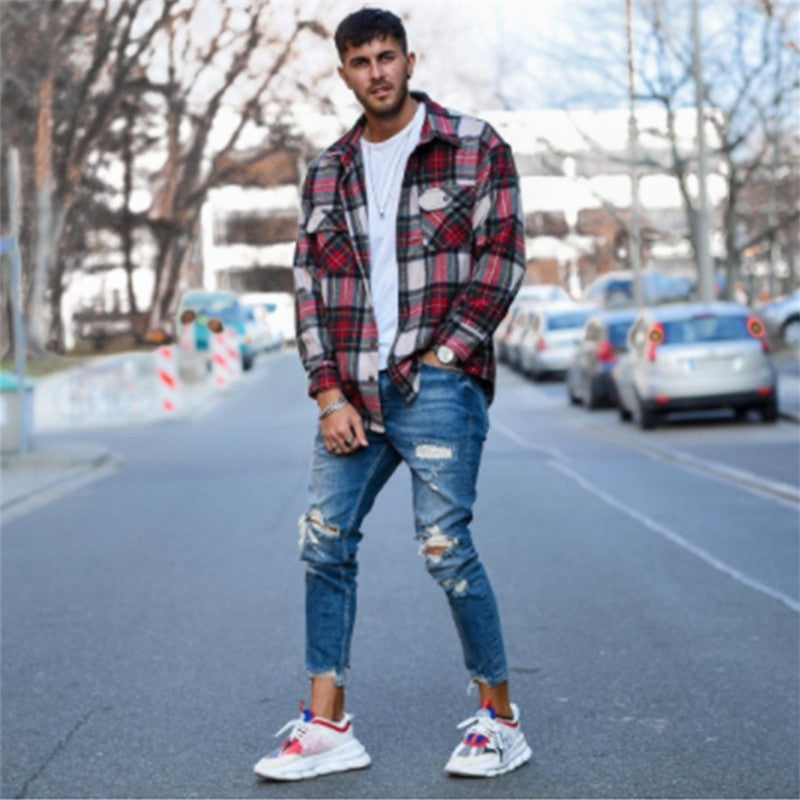 Men's deep blue ripped jeans with distressed knee and thigh panels, slim fit