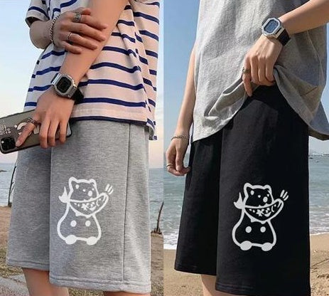 Straight sports shorts in light gray and black, each featuring a white cat graphic on the front.