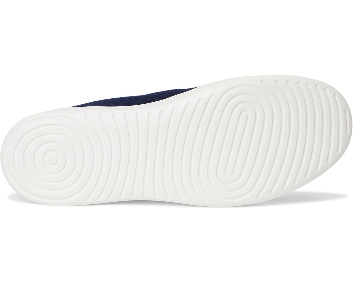 Outsole view of dark navy wool slip-on shoes with white rubber tread