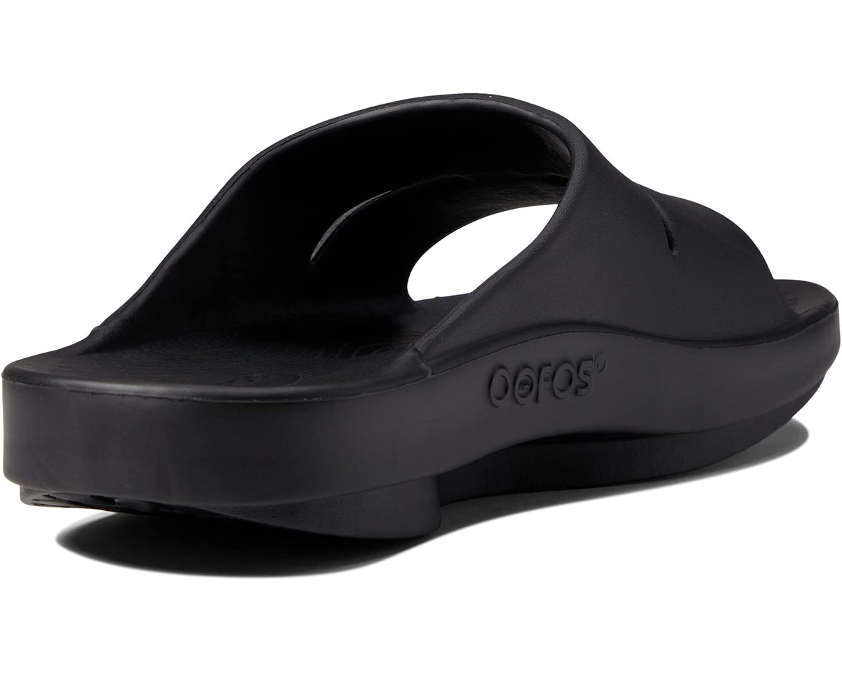 Black slide sandal heel view with molded footbed and OOFOS logo