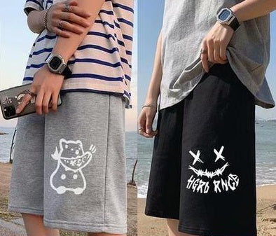 Straight sports shorts pair: light gray and black, each with white cartoon-style graphic.