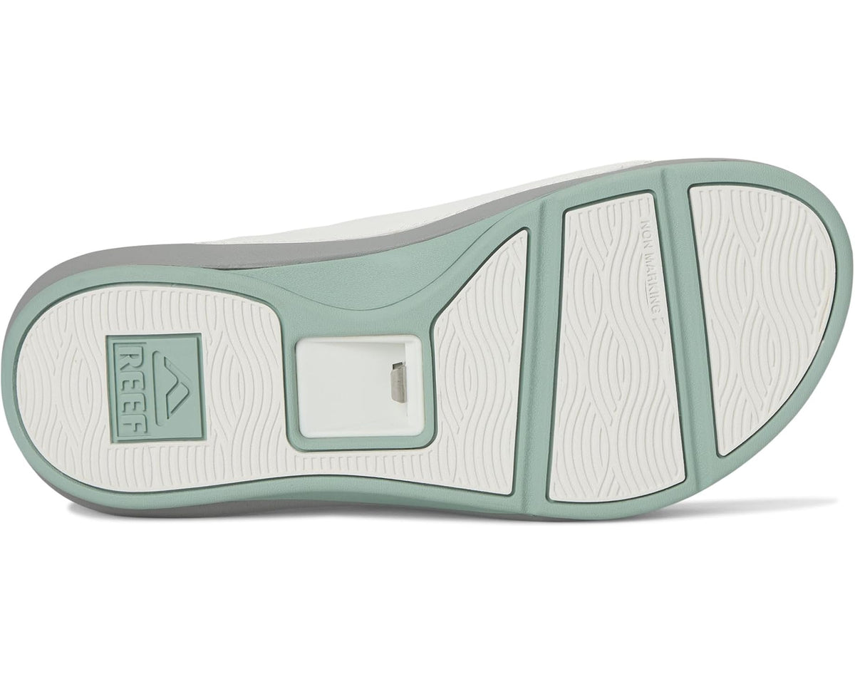 Reef Swell Cruiser slide sandal outsole with white tread panel and green edge