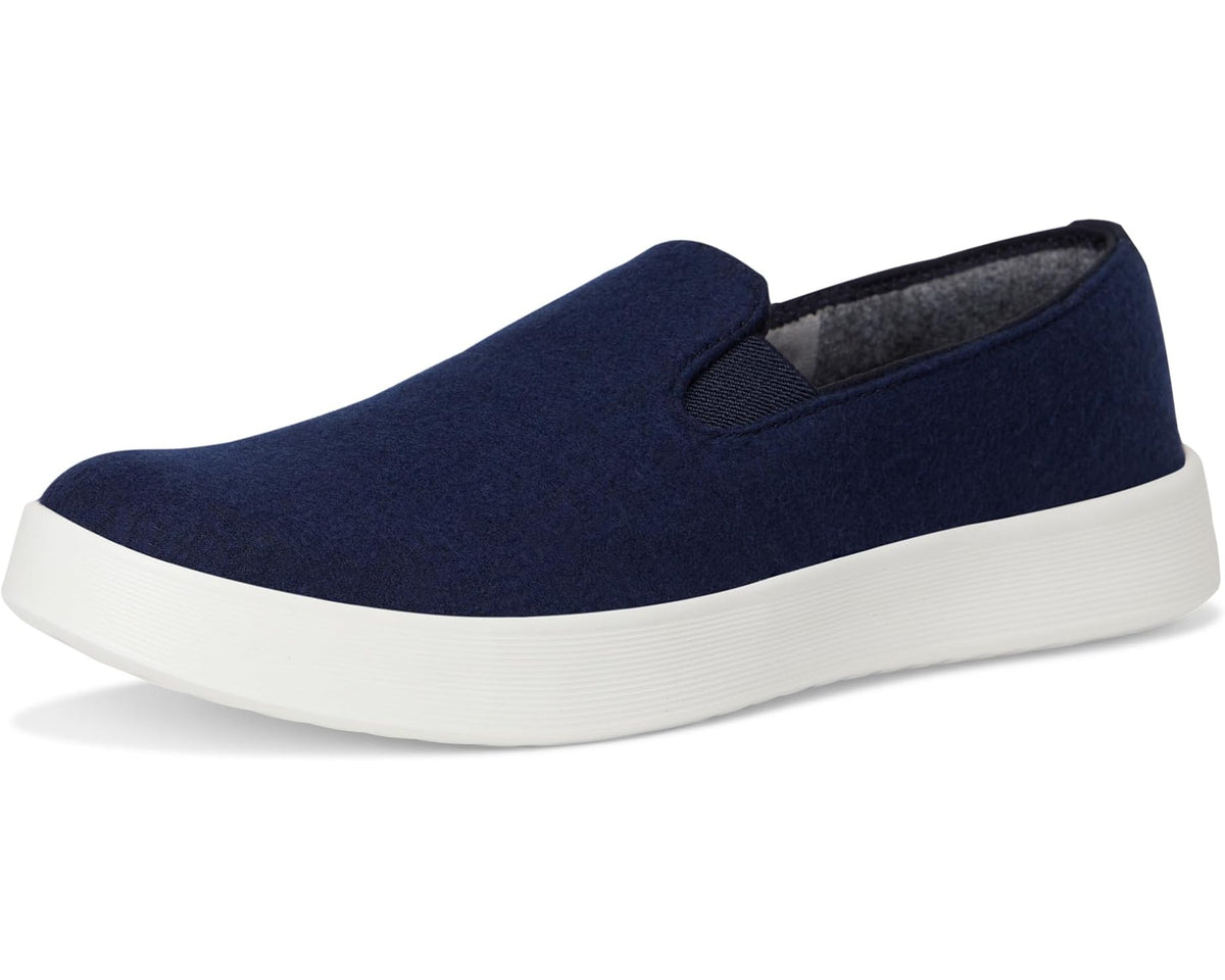 Three-quarter view of dark navy wool slip-on shoes with white rubber sole