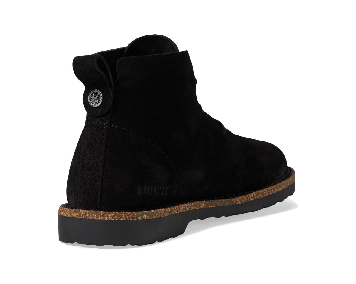 Black suede mid lace-up boots, heel/side view with circular logo patch