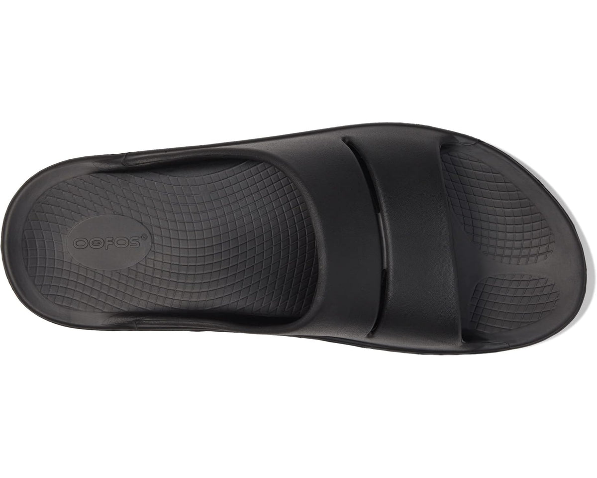 Black slide sandal with textured footbed and two strap detail