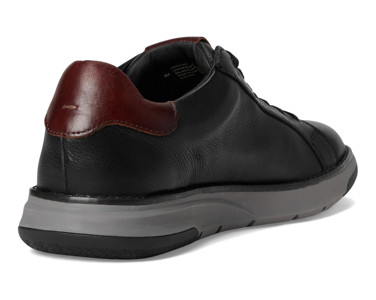Men's black sneaker heel with brown leather pull tab and molded rubber sole