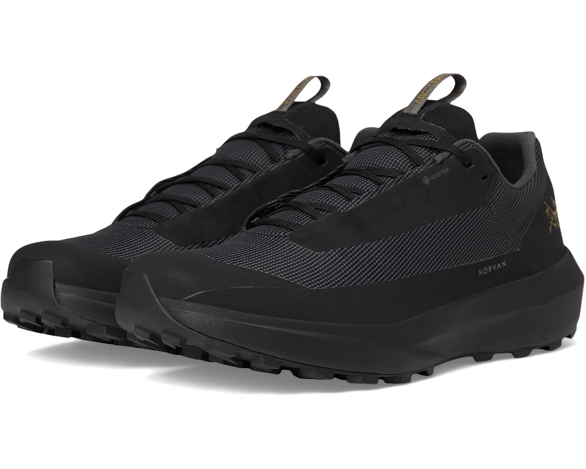 Unisex black low-top trail shoes with mesh upper, lace-up closure and rubber outsole