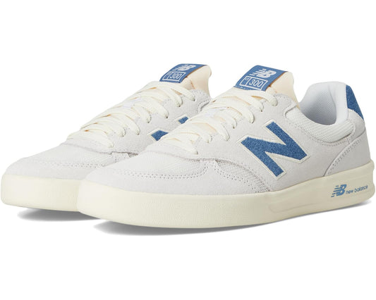 Unisex New Balance 300 court sneakers in white with blue N logo and cream sole