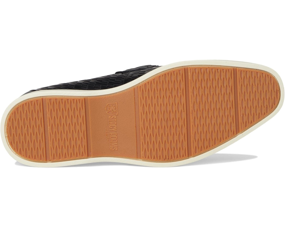 Black moc toe slip-on loafers outsole view with tan grip pattern