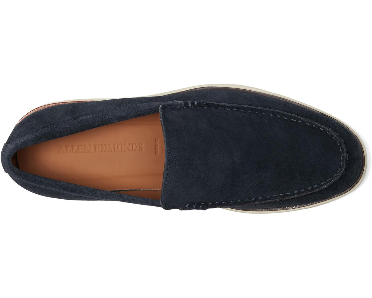 Men's navy suede loafer with tan lining, slip-on opening, and side seam stitching