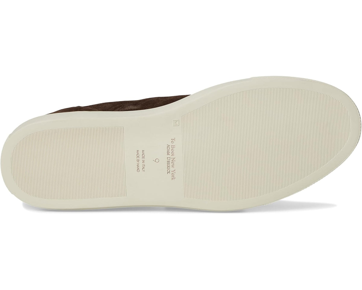 Dark brown suede sneaker outsole view with textured white rubber sole