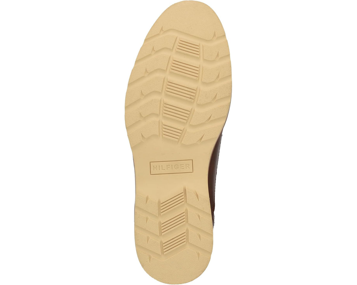 Outsole view of cognac leather lace-up shoe with textured cream rubber tread