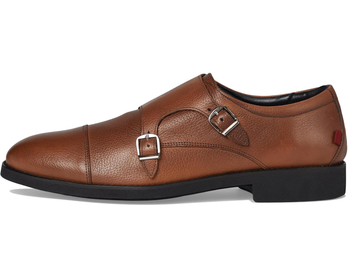 Men's cognac leather monk strap shoes, angled front view with buckle straps