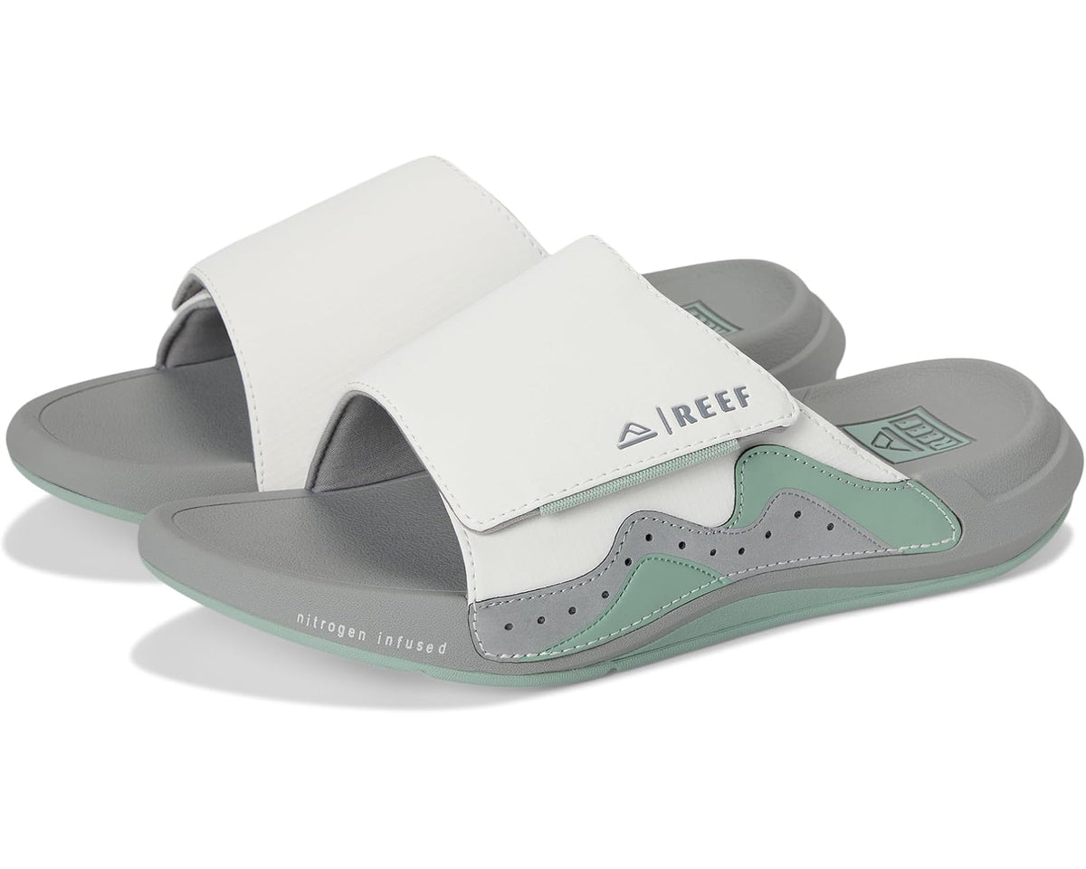 Reef Swell Cruiser slide sandals with white upper, grey base, and green accents
