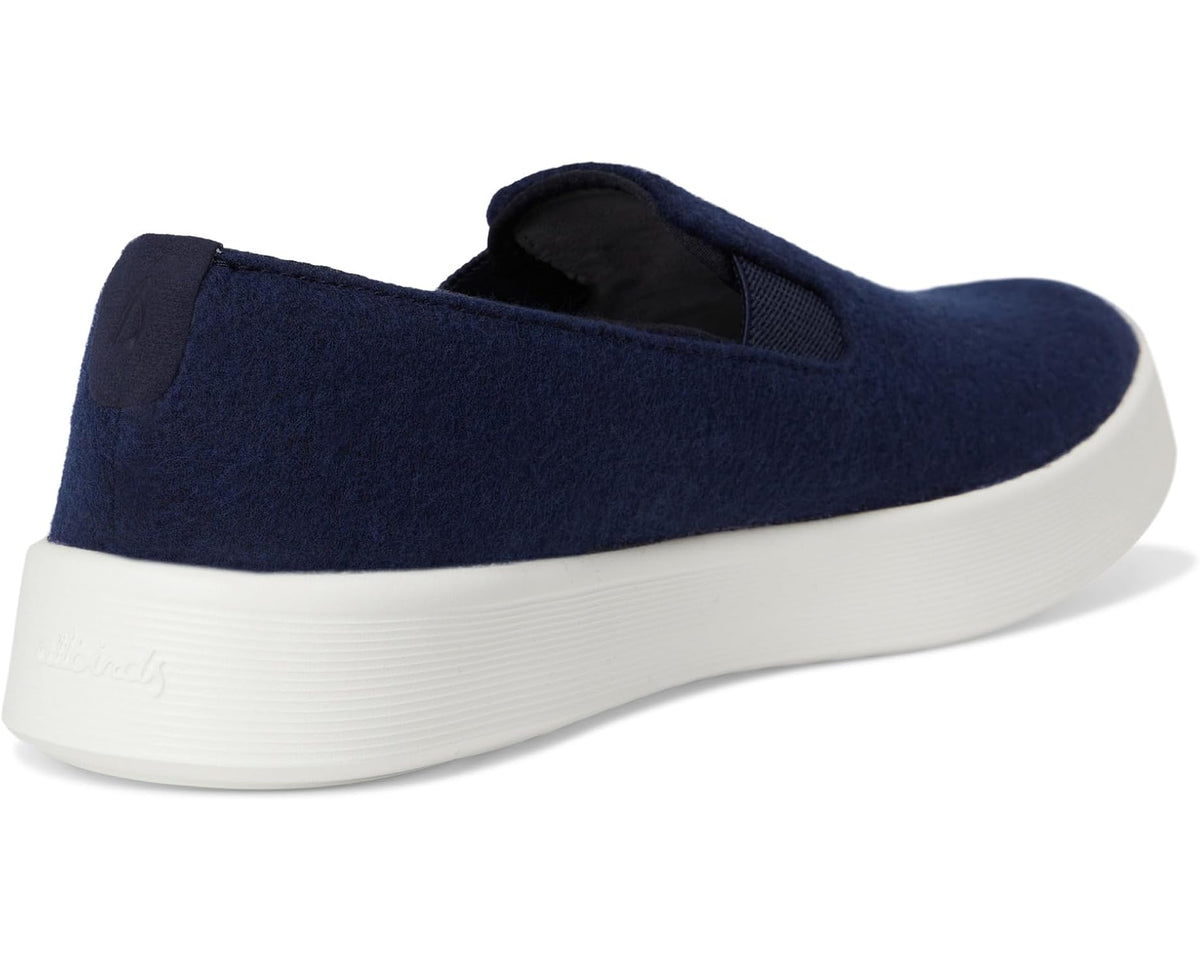 Back view of dark navy wool slip-on shoes with padded collar and white sole