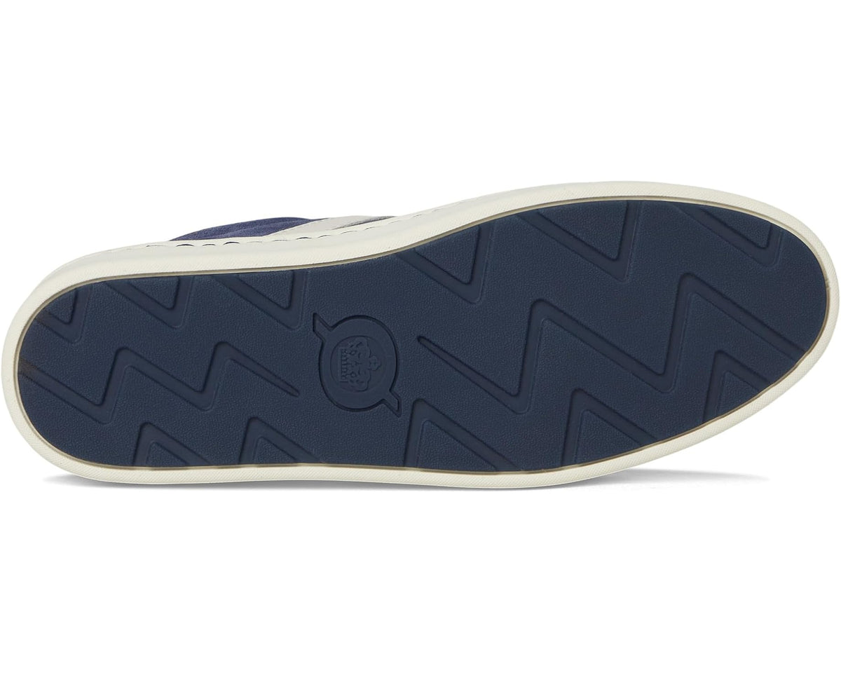 Navy rubber outsole with zigzag tread on a slip-on sneaker