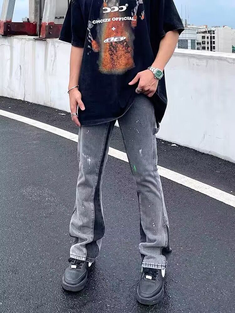 Gray distressed denim jeans with paint splatter, straight legs, and stitched seams