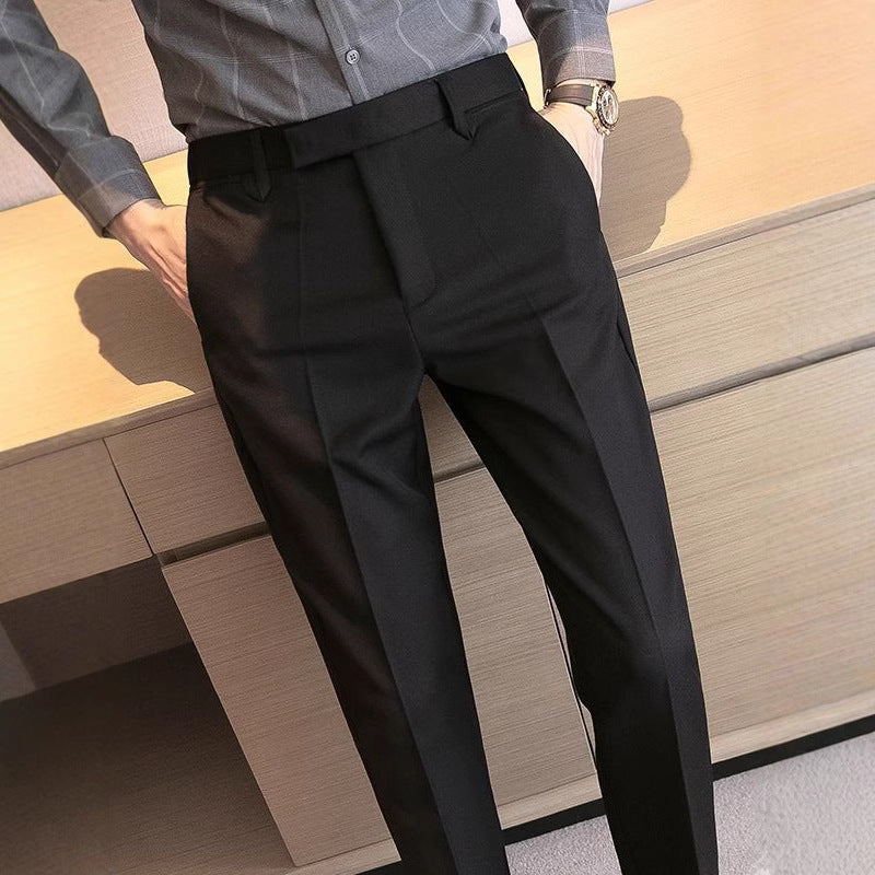 Men's black dress pants with belt loops, pleated waist, and slim straight legs