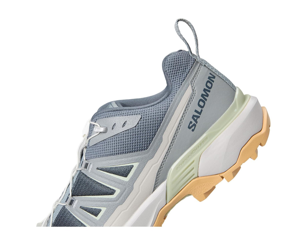 Men's trail shoe side view with Salomon branding, blue-gray upper, light green midsole
