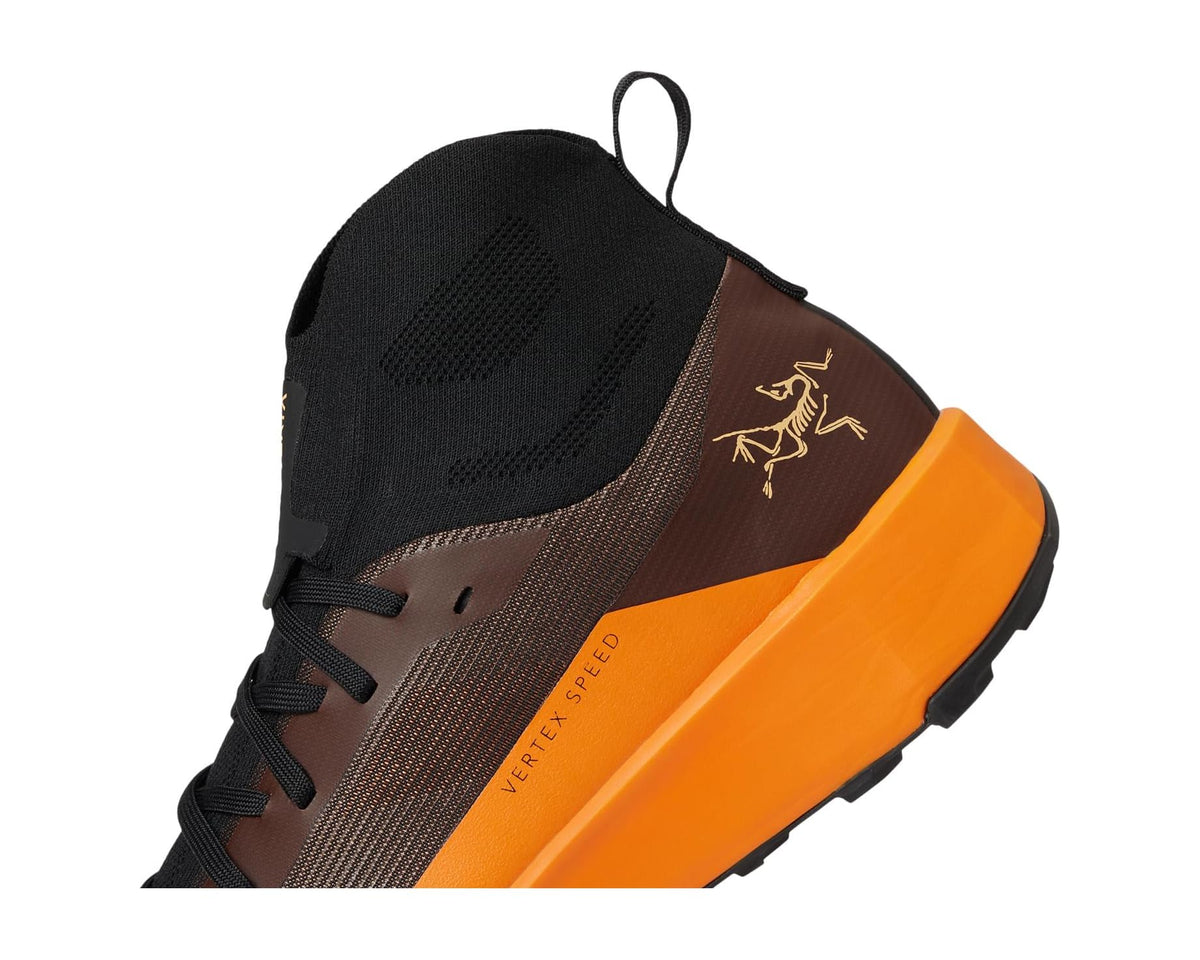 Men's Arc'teryx trail shoe detail, brown upper with black lace tabs and orange edge