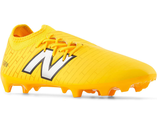 Yellow FG soccer cleat with black New Balance logo and orange studs