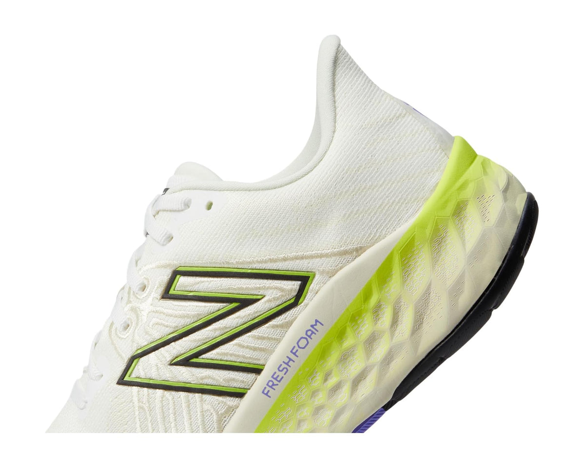 Men's New Balance running shoes, side view with N logo and neon green midsole