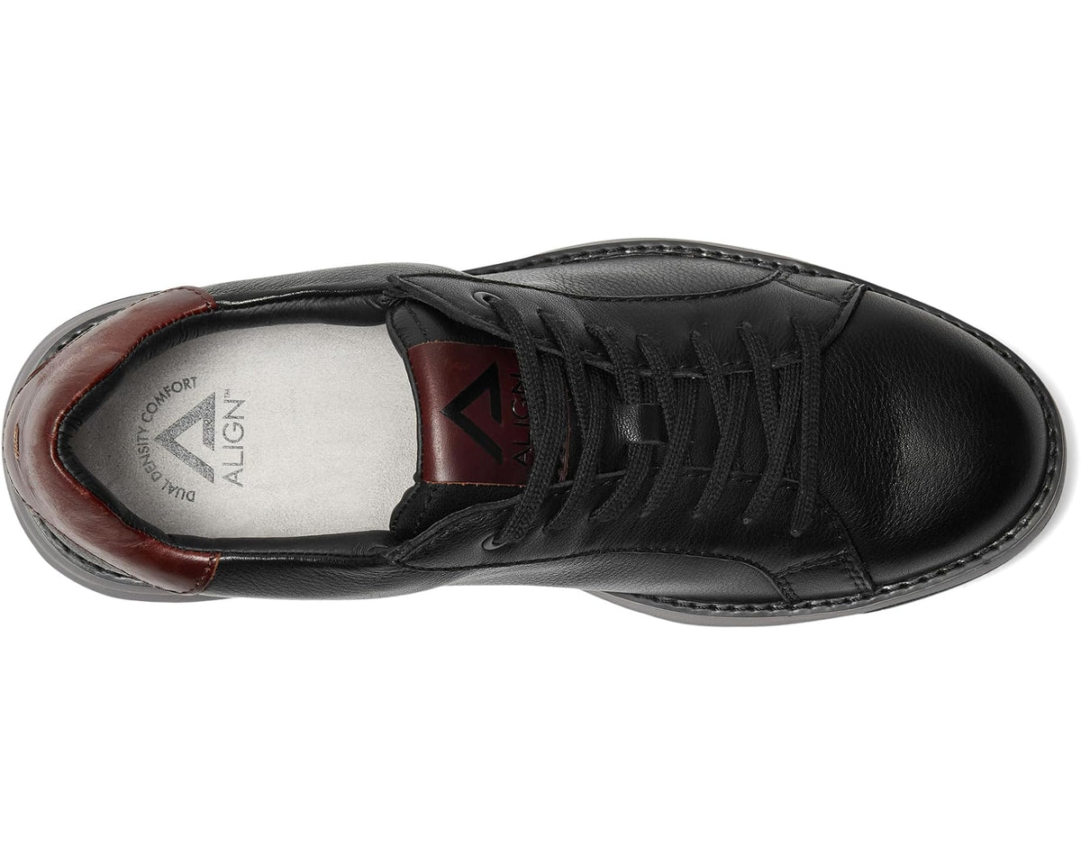 Men's black sneaker interior view with lace panel and brown lining trim