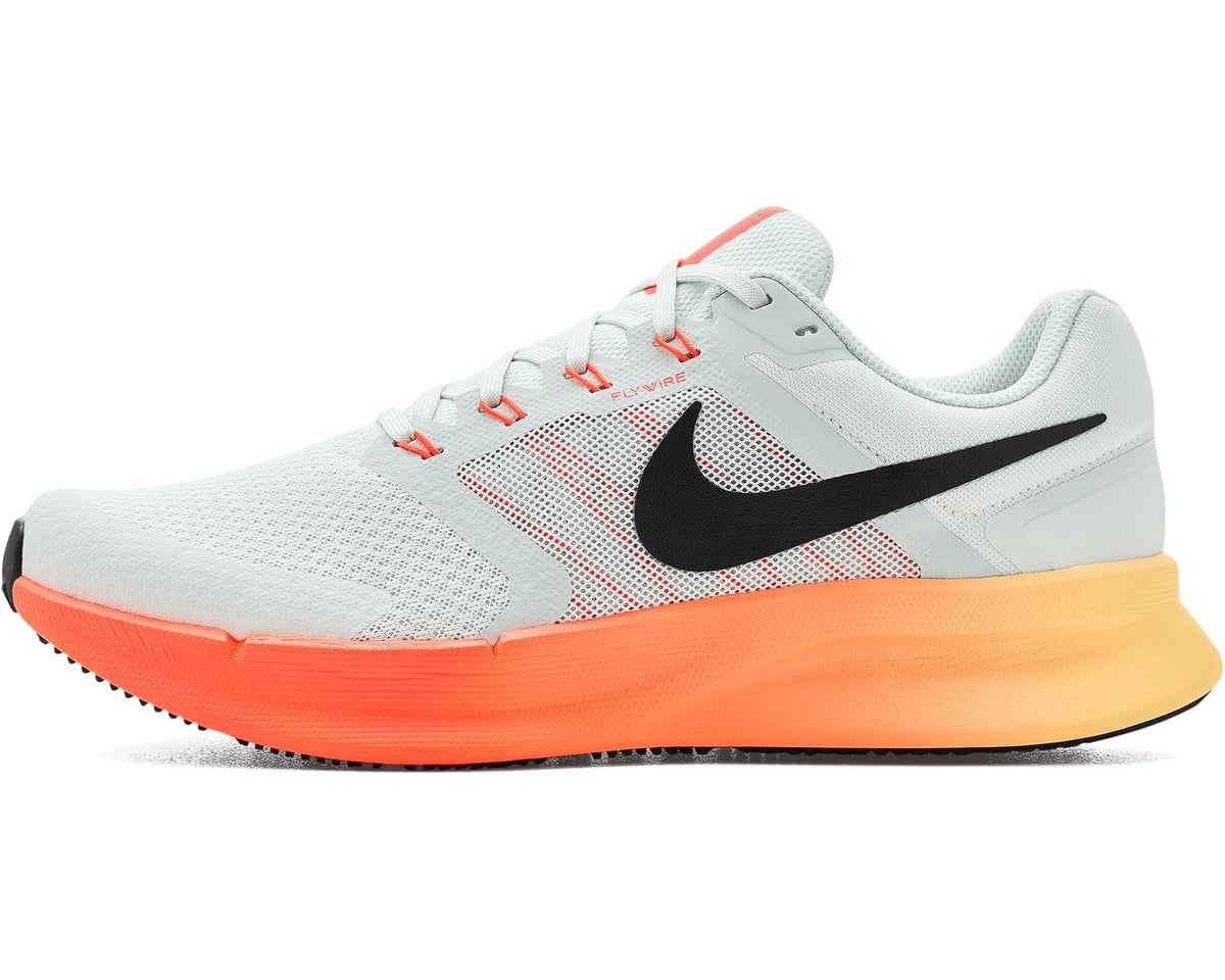 Men's Nike running shoes with light gray upper, black swoosh, and orange midsole.