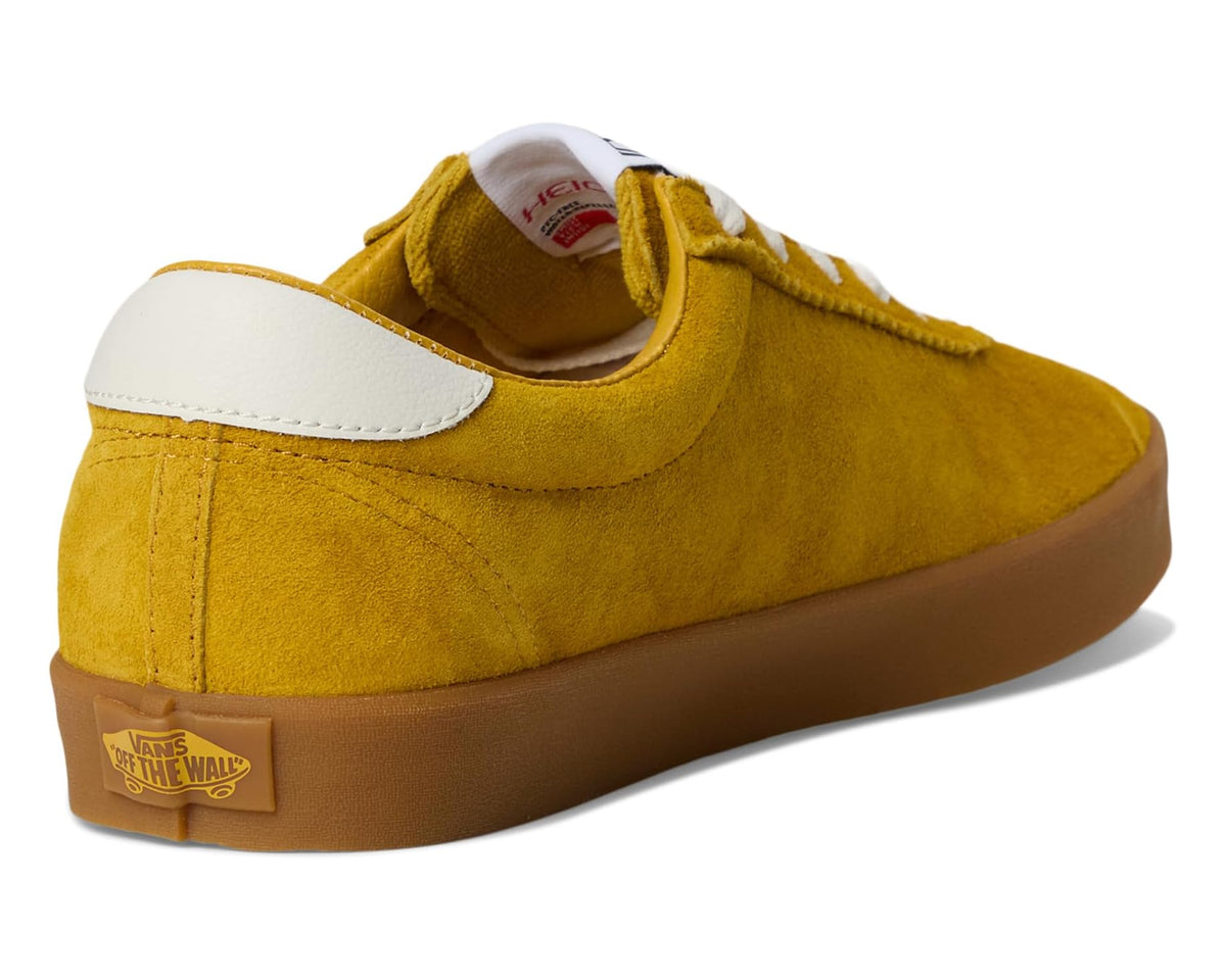 Back view of mustard suede low-top sneakers with white heel panel and gum sole