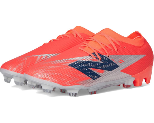 Unisex soccer cleat in bright red with white and navy New Balance logo, FG studs