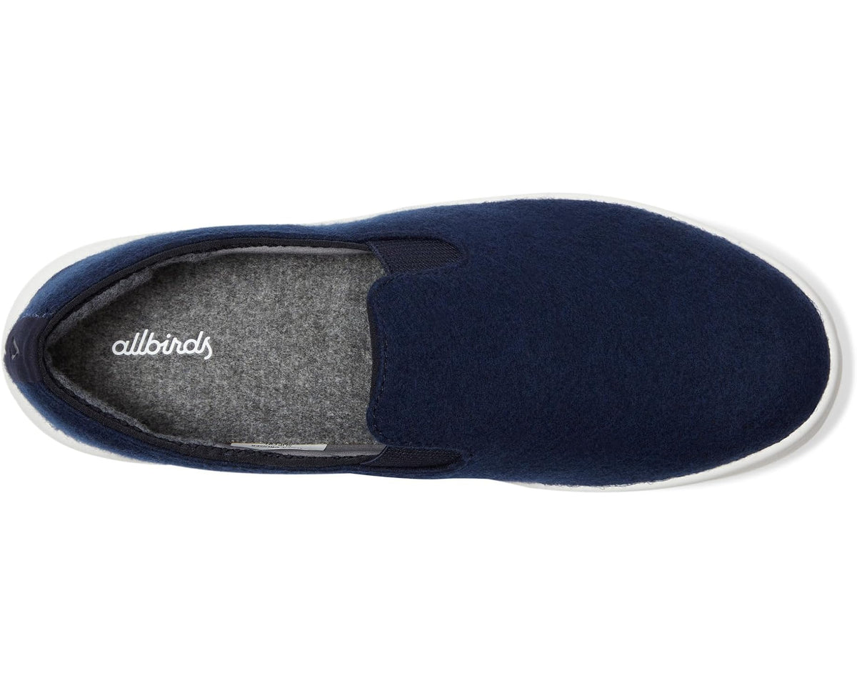 Dark navy slip-on shoe with gray insole and allbirds logo at the opening