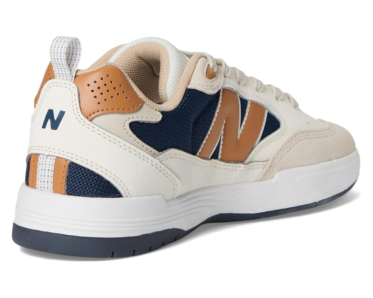 New Balance sneakers heel side, navy and tan accents with white midsole
